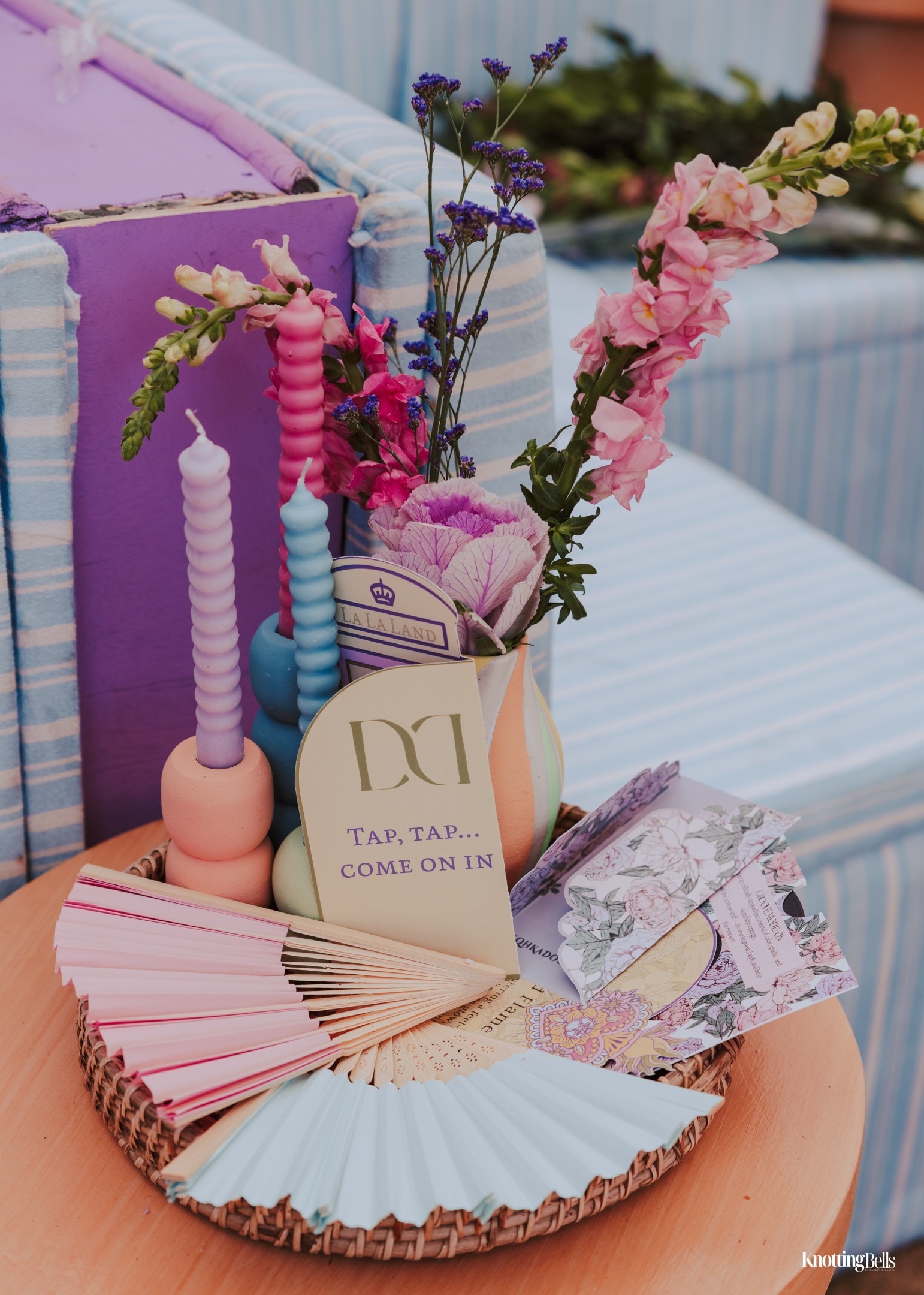 Lala Love Land table detail with pastel candles, florals and DD welcome card